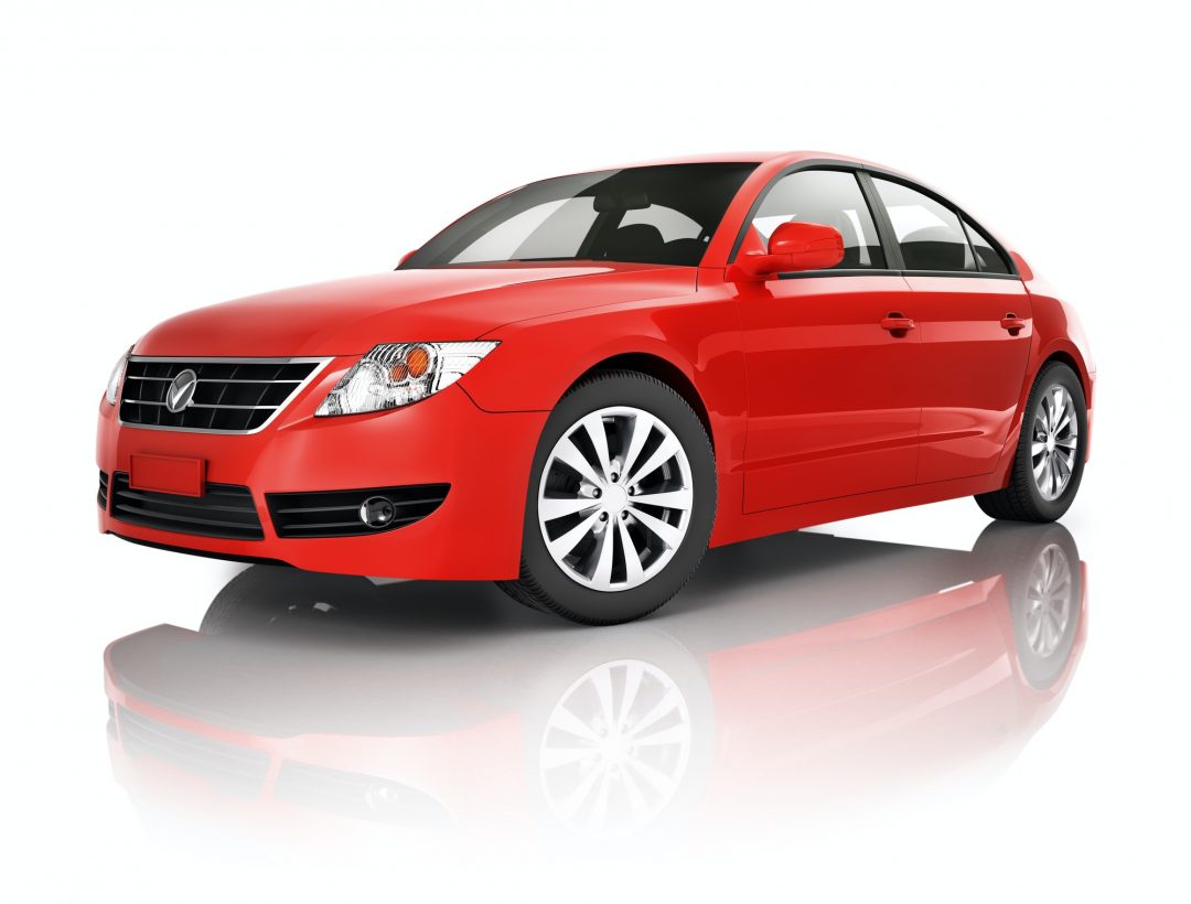 A shiny red sedan with silver alloy wheels, viewed from a frontal side angle on a white reflective surface.